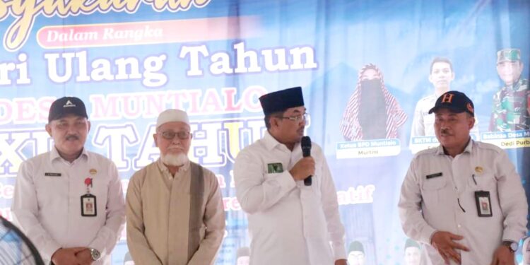 HUT Desa Muntialo, Bupati Himbau Masyarakat Manfaatkan Lahan Kosong Tanam Padi